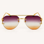 Vista frontal do Mionelle Halo Amethyst, com estrutura dourada e lentes em degradê roxo e âmbar