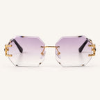 Vista frontal dos óculos Mionelle Facet Purple, com lentes lilás em degradê e estrutura dourada